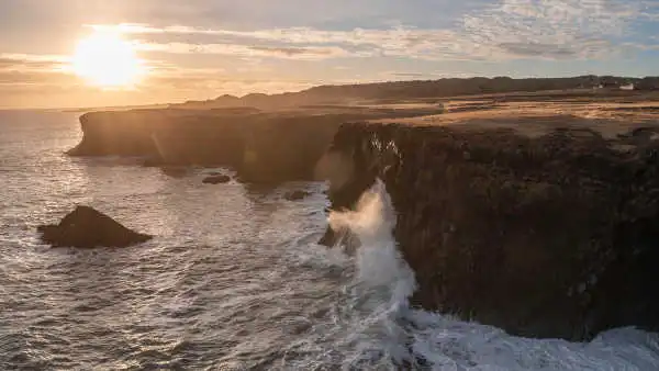 Cliffs of basaltic columns at sunset